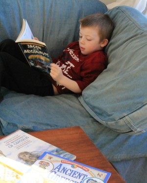 boy reading Greek Myths