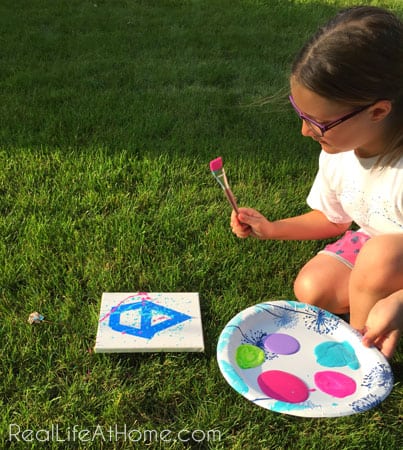 Outdoor splatter painting activity for kids