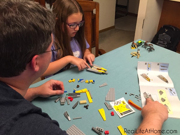 Dad and Daughter building LEGO Star Wars construction set together