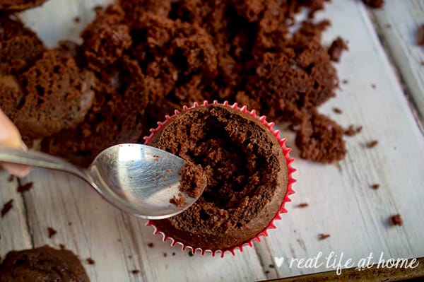 Hot Cocoa Cupcakes - scooping crater out of cupcake