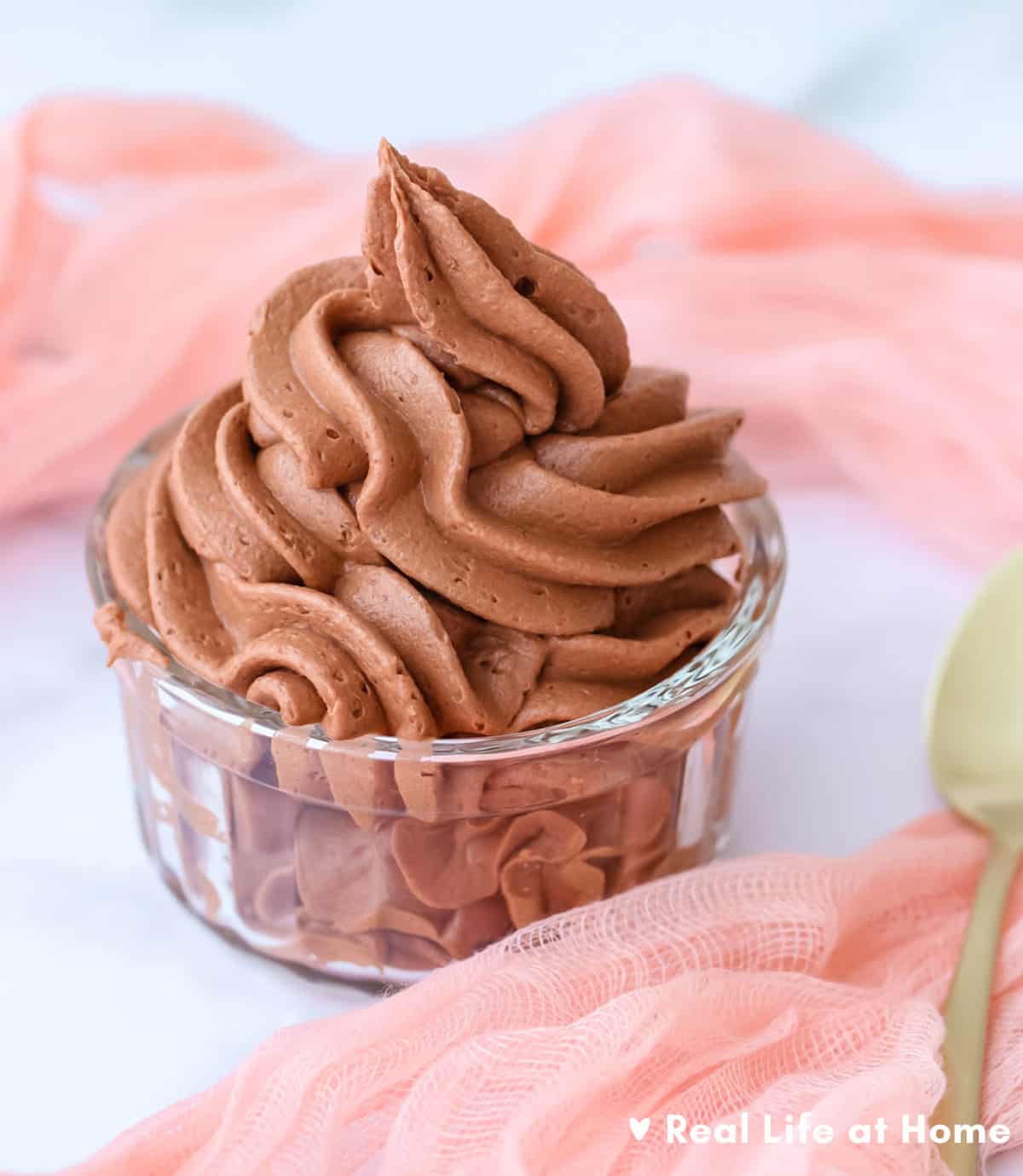 Homemade Chocolate Buttercream Frosting in a Glass Cup